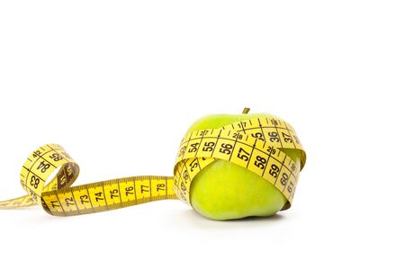 Green apple with measuring tape isolated on whiteの写真素材