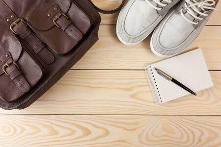Outfit of traveler, student, teenager, young man, objects on wooden backgroundの写真素材