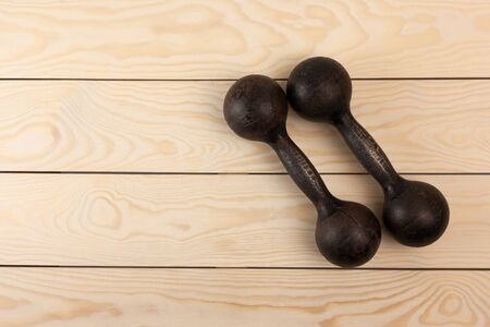 old dumbbells on white  wood backgroundの写真素材