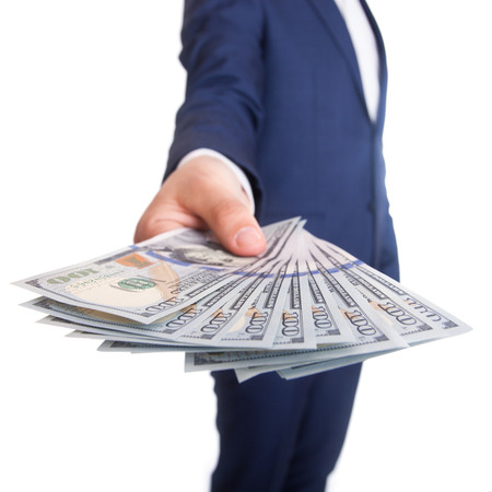 Business man Displaying a Spread of Dollar isolated on white
