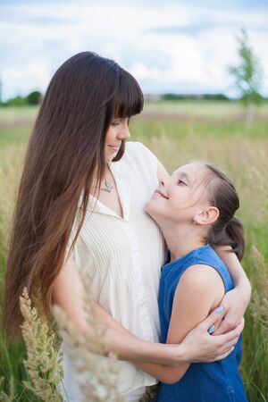mother and daughter in fieldの写真素材