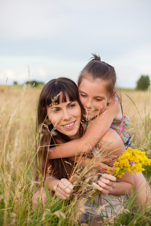 Mother and daughter in the fieldの写真素材