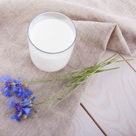 milk cup, flower on wooden tableの写真素材