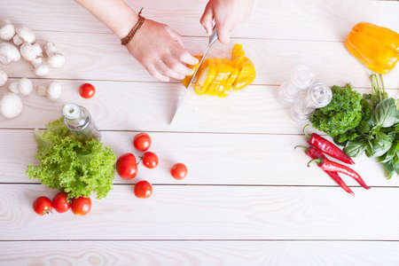 chopping vegetables on wooden tableの写真素材