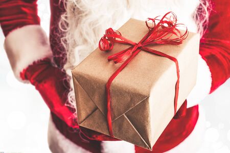 Santa Claus holding a gift in his handの写真素材