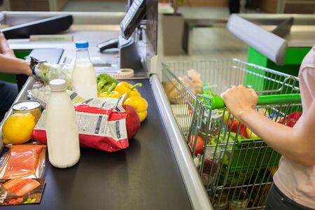 Young woman buying food at the grocery storeの写真素材