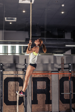 Fitness rope climb cxercise In crossfit gym.の写真素材
