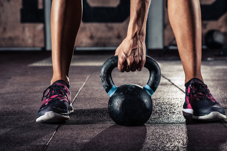 Crossfit kettlebell training in gymの写真素材