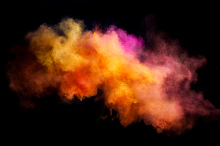 Freeze motion of colored dust explosion isolated on black backgroundの写真素材