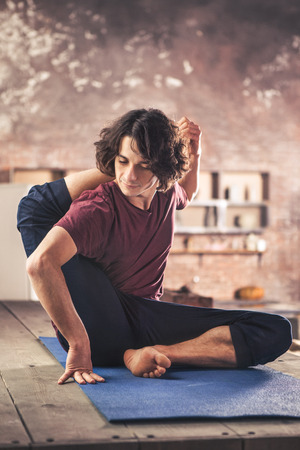 Man doing yoga exercises. Practicing yogaの写真素材