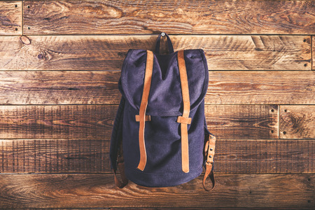 Canvas and leather backpack on wooden wallの写真素材