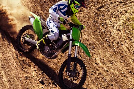 Motocross rider in action accelerating the motorbike  on the race track.の写真素材