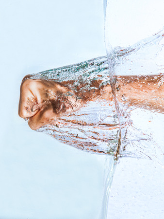 Fist punching water splashの写真素材