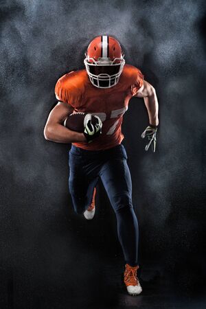 American football sportsman player running in actionの写真素材