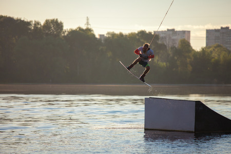 Man makes an extreme jump on wakeboard. Sport and active lifestyle.の写真素材