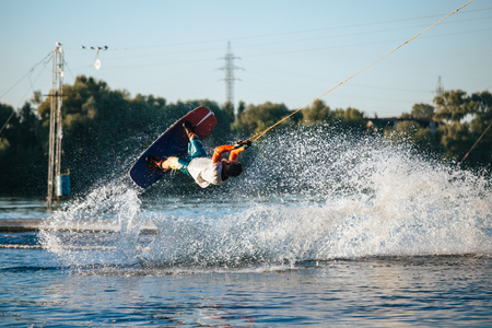 Wakeboarder sportsman jumping with rotation in the cable park, sport and active lifestyleの写真素材