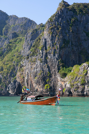 Long tail boat on the sea with rock on backgroundの写真素材