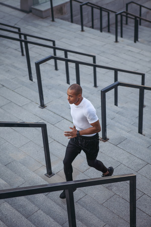 Portrait of Afro-American sportsman running up stairsの写真素材
