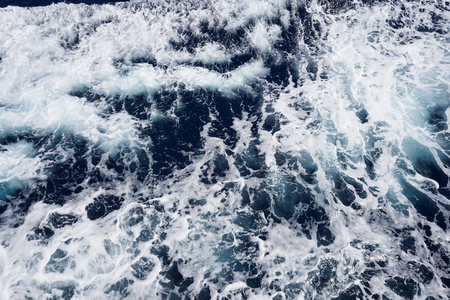 Aerial view to ocean waves. Blue water backgroundの写真素材