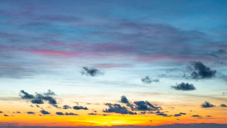 Sunset sky began to change from blue to orange.の写真素材
