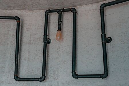 loft style metal pipe with edison light bulb.