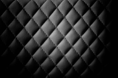 Black leather background. Leather stitched with threads.