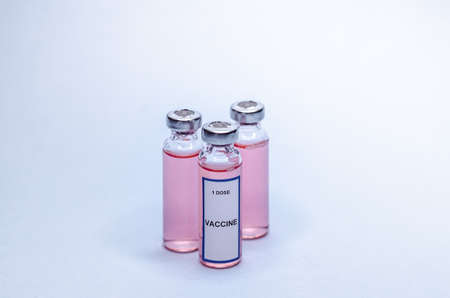 Vaccine in glass bottles on a white background. Three vials with one dose of vaccineの写真素材
