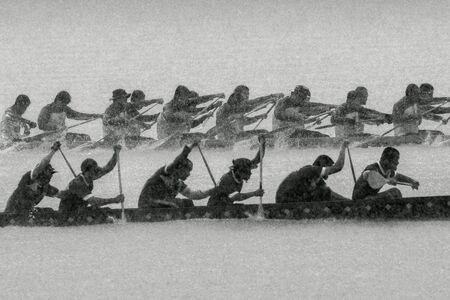 Traditional Thai long boat racing on raining day.