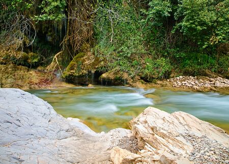 Water flow detail and rocks in Neda river, Peloponnese, Greece.の写真素材