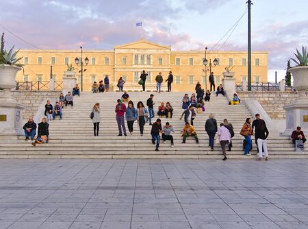 Athens / Greece - November 02 2019: Commuters and tourists at Syntagma square steps. Greek parliament building in the background.のeditorial素材