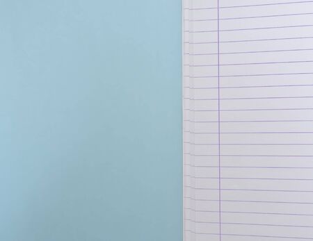 Open blank  notebook with lined papers on light blue background with copy space.の写真素材