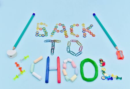 Back to school text made with colorful  school suplies against light blue background.の写真素材