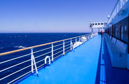 Man walking alone on ship ferry deck , during sail in Aegean sea, Greece.の写真素材