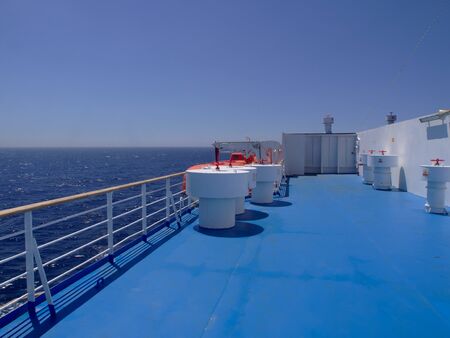 Ship ferry blue colored deck with  no people while sailing at Aegean sea , Greece.