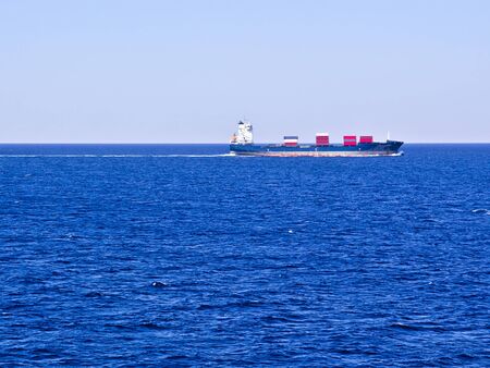 Large cargo ship sailing at textured sea.の写真素材