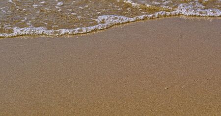 Beach close up on sand and sea waterの写真素材