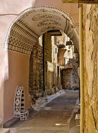 Narrow alley with decorated tunnel, in Pyrgi  medieval village, Chios island, Greece.の写真素材