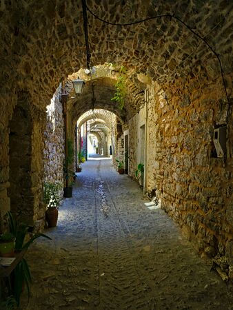 Narrow alley at the medieval castle village of Mesta in Chios island , Greece.の写真素材