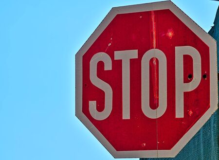 Vivid road stop sign against blue sky background.の写真素材