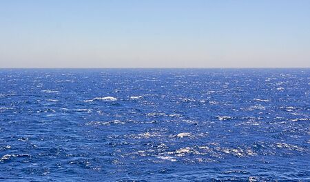 Wavy deep blue sea and sky.の写真素材