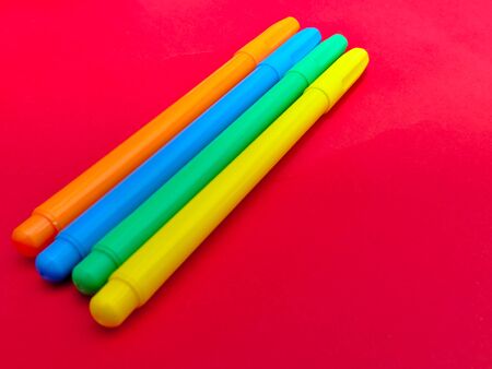 Colorful markers on red background with copy space.の写真素材