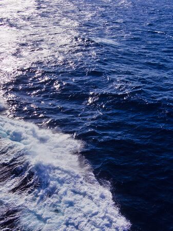 Sea water foam made from moving ship and sunlight reflection.の写真素材