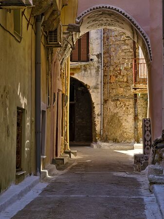 Narrow alley with decorated tunnel, in Pyrgi  medieval village, Chios island, Greece.の写真素材