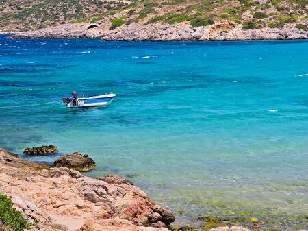 Boat on turquoise water,  beautiful beach of Agia (Saint) Dynami (Force) in Chios island, Greece.の写真素材