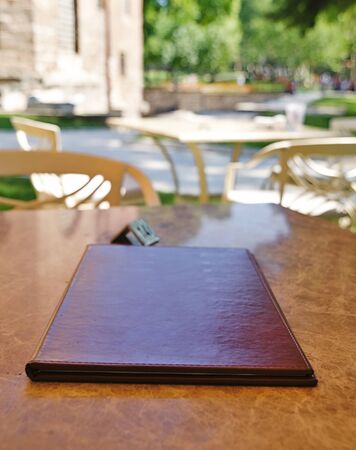 Menu catalog close up on restaurant table, selective focus.
