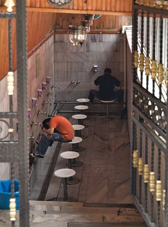 Two muslim men perform ablution (wudhu) before prayer, Istanbul, Turkey.の写真素材