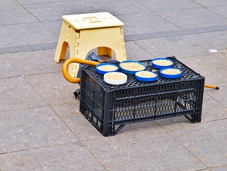 Seeds in plastic containers for feeding birds on a  lug used as pedler workbench in  Ortakoy, Istanbul Turkey.の写真素材