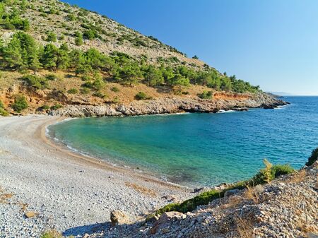Isolated empty beautiful stone beach at summer time, in central west Chios island, Greece.の写真素材
