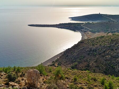 View from above, coastline in Chios island Greece. Bright day sunlight reflecting on water.の写真素材