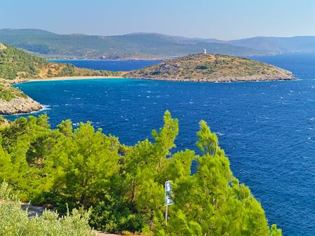 View from above, cape with stone watchtower in Chios island Greece. Fortified medieval cylindrical tower above sea.の写真素材